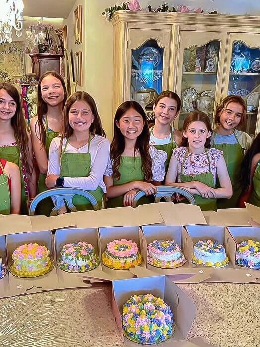 A group of girls posed for a photo after decorating their cakes.